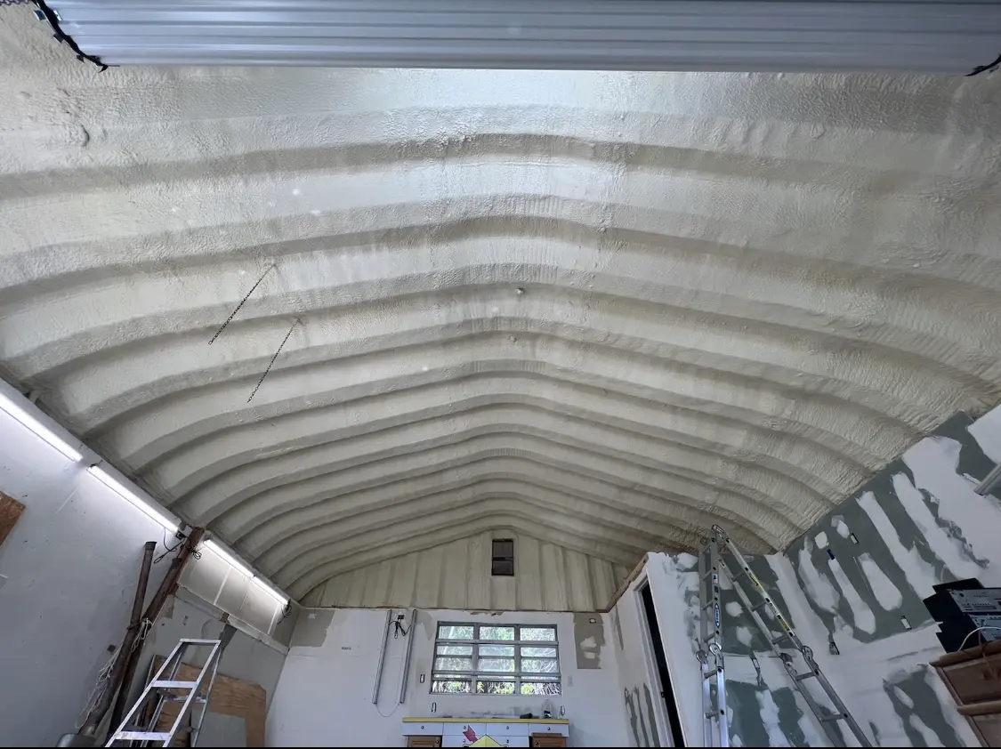 Spray polyurethane foam applied to the underside of a metal roof deck in Linda